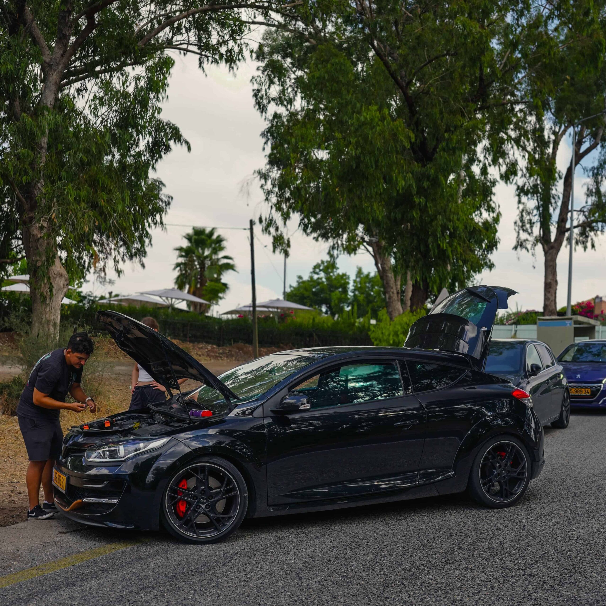 בחור שמטפל ברכב שלו בטבע